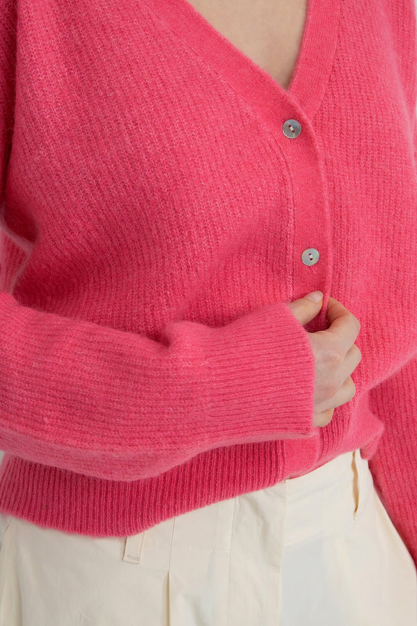 features a cozy, retro-inspired outfit highlight, specifically a vibrant orange cardigan main image 1